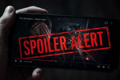 A smartphone paused on a movie trailer with a red SPOILER ALERT stamp cracking the screen, hands covering eyes in frustration