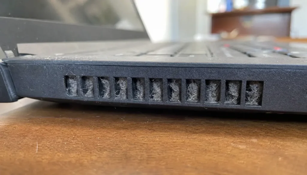 dusty laptop vent showing signs of blocked airflow